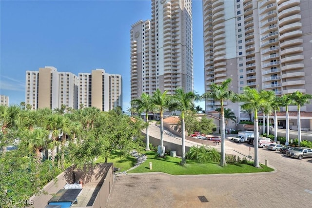 view of property with a city view and uncovered parking