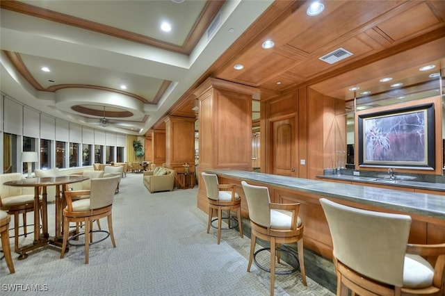 bar with ornamental molding, visible vents, recessed lighting, a baseboard heating unit, and carpet flooring