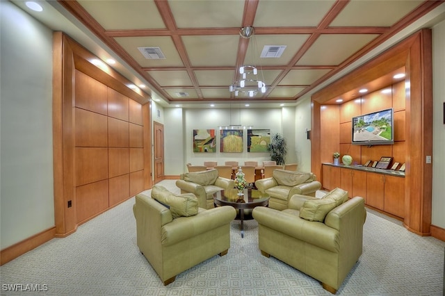 carpeted living room with coffered ceiling and beamed ceiling