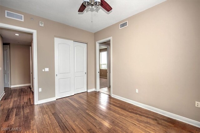 unfurnished bedroom with a closet, ceiling fan, and hardwood / wood-style floors