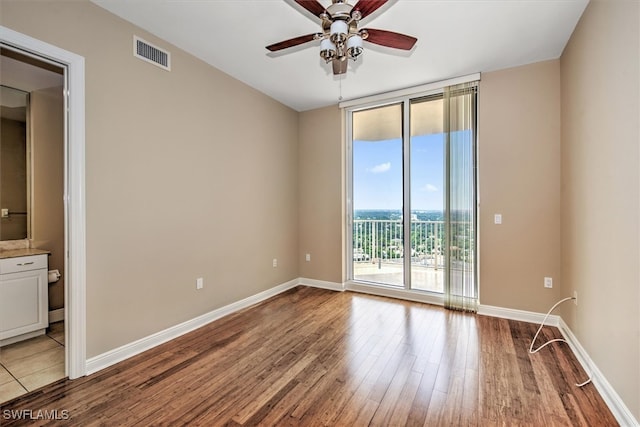 spare room with ceiling fan and wood-type flooring