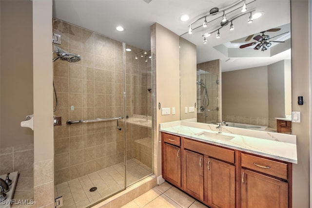 bathroom featuring ceiling fan, a shower with door, tile patterned flooring, vanity, and a tray ceiling