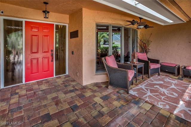 property entrance with a patio and ceiling fan