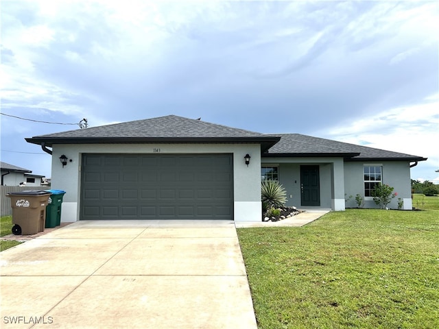 view of front of house featuring a garage and a front lawn