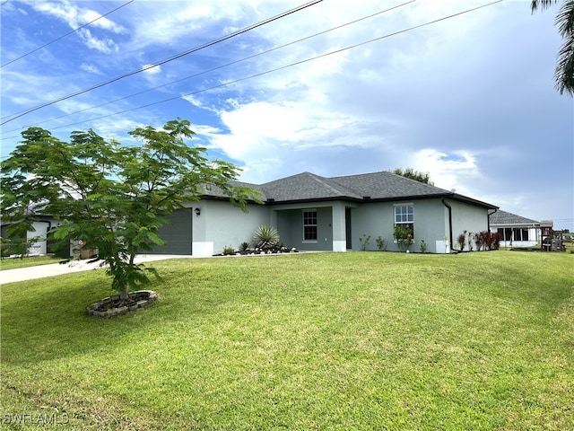 ranch-style house featuring a garage and a front yard