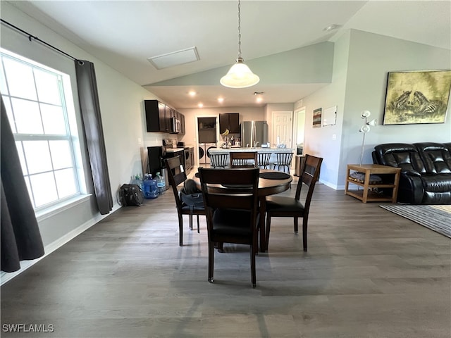 dining area with a wealth of natural light, lofted ceiling, and hardwood / wood-style floors