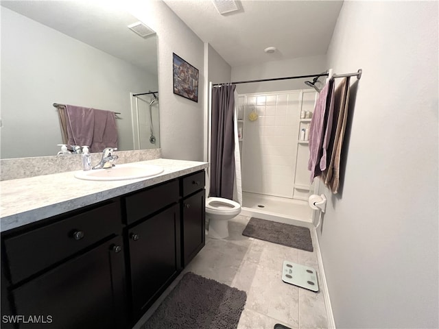 bathroom with tile patterned flooring, a shower with curtain, vanity, and toilet