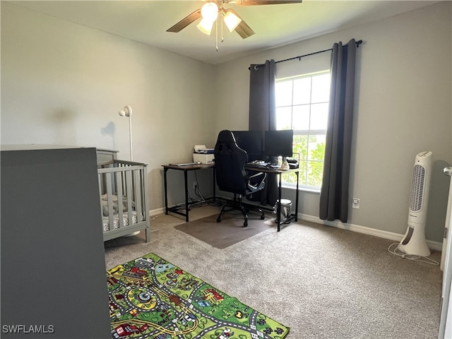 carpeted office space featuring ceiling fan