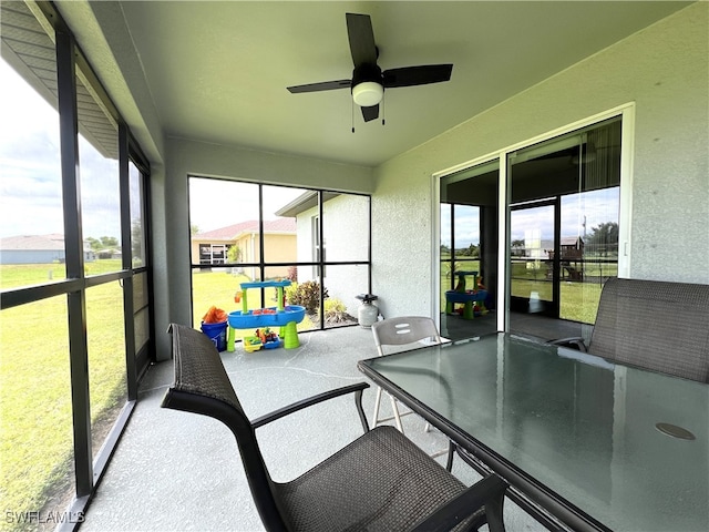 sunroom / solarium with plenty of natural light and ceiling fan