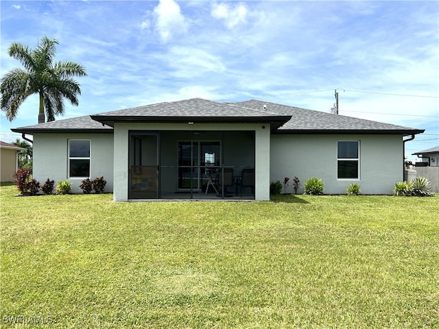 rear view of house with a yard