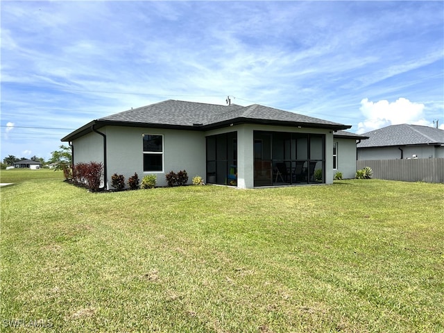 back of house featuring a sunroom and a yard