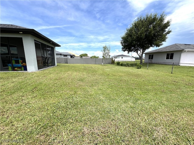 view of yard featuring a sunroom