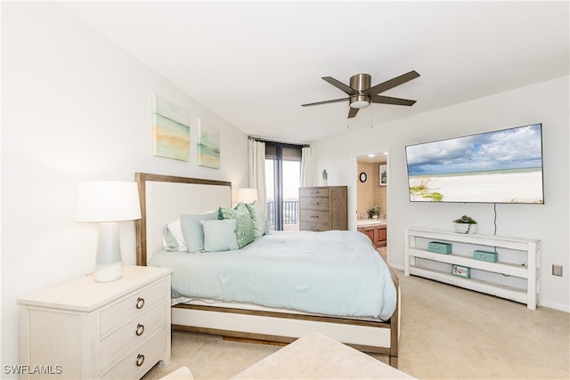 carpeted bedroom with ceiling fan and ensuite bath