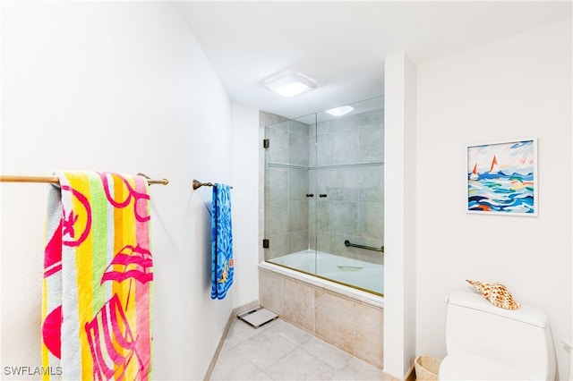 bathroom with toilet, tile patterned flooring, and enclosed tub / shower combo