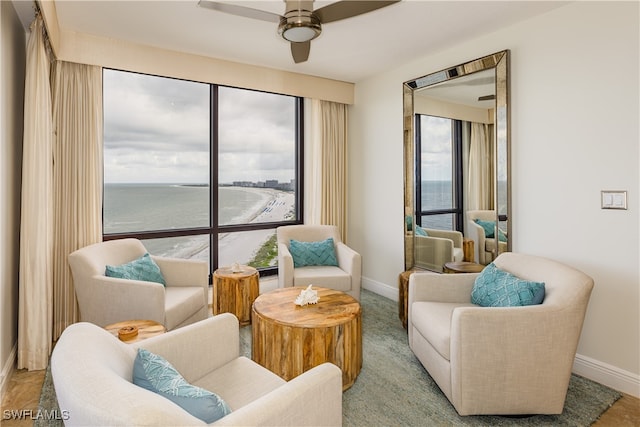 interior space with ceiling fan and a water view