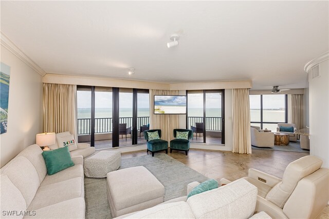 living room with ceiling fan, light tile patterned floors, crown molding, and a water view