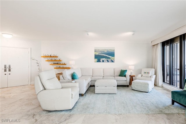 tiled living room with a wealth of natural light and ornamental molding