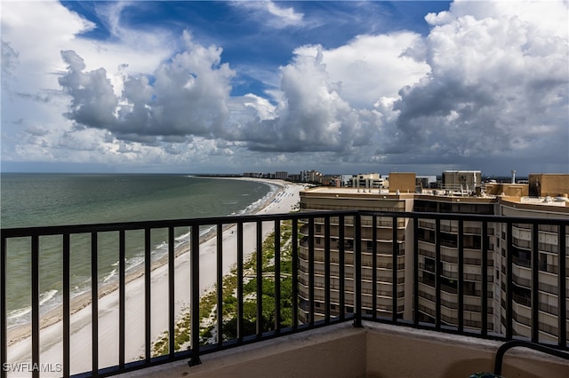 balcony featuring a view of the beach and a water view