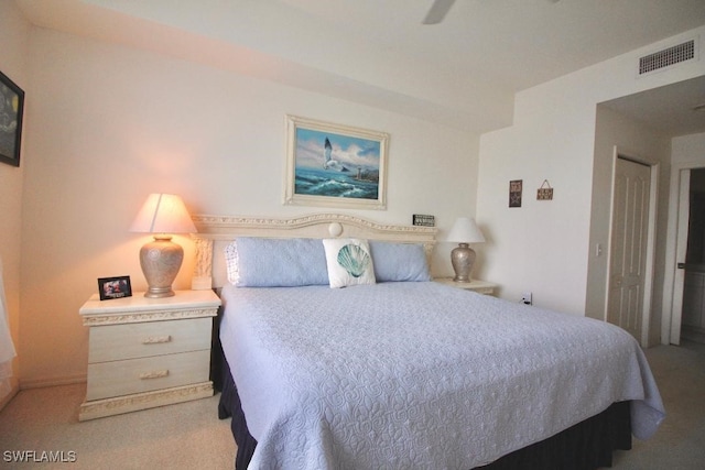 bedroom with ceiling fan and light colored carpet