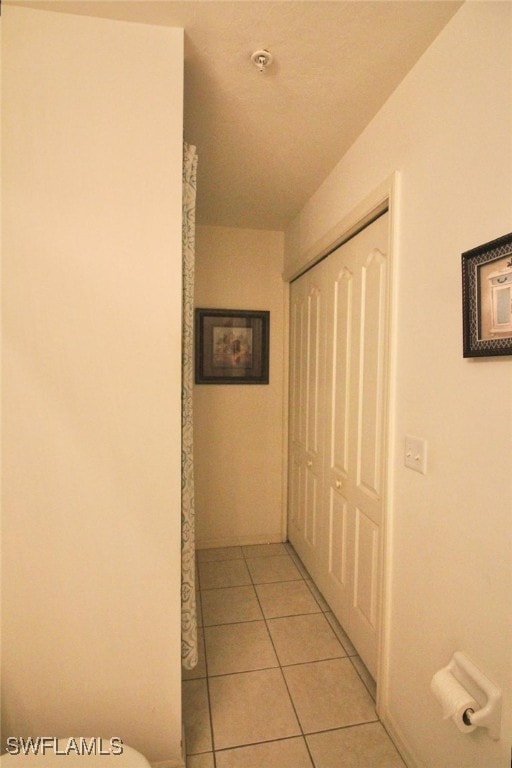 corridor with light tile patterned floors