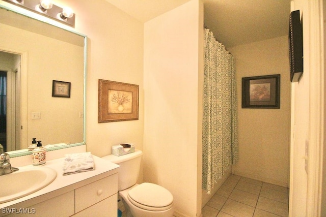 bathroom with tile patterned flooring, vanity, and toilet