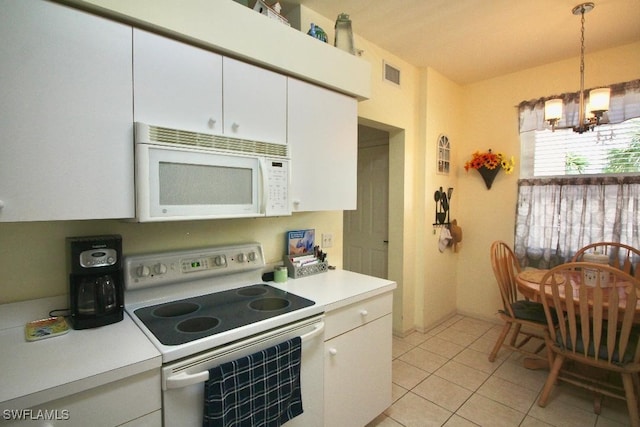 kitchen featuring pendant lighting, light tile patterned floors, white appliances, a notable chandelier, and white cabinets