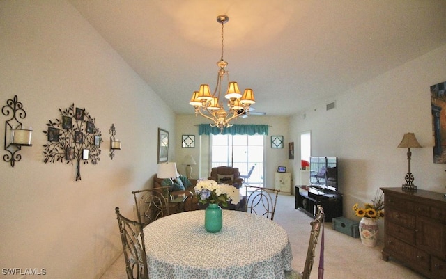 carpeted dining room with an inviting chandelier