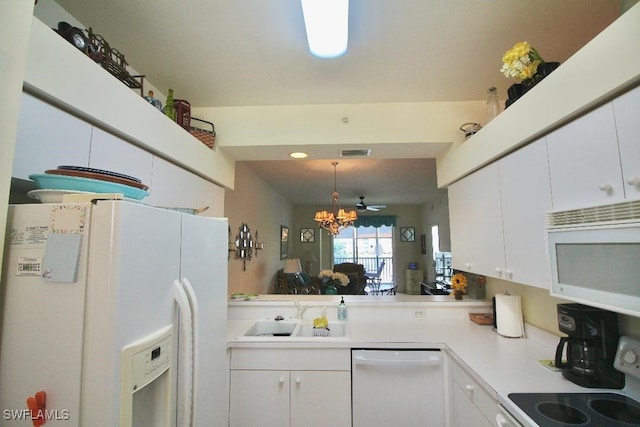 kitchen featuring ceiling fan with notable chandelier, sink, white cabinets, and white appliances