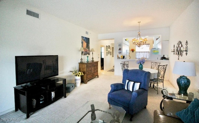 carpeted living room with a notable chandelier