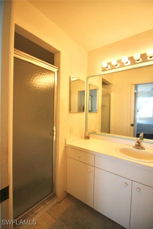 bathroom featuring tile patterned flooring, vanity, and an enclosed shower