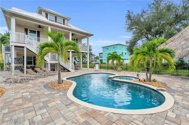 view of swimming pool with an in ground hot tub, ceiling fan, and a patio area