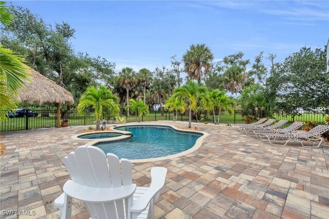 view of pool featuring a gazebo, a patio area, and an in ground hot tub