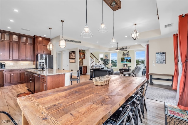 dining room featuring ceiling fan and light hardwood / wood-style floors