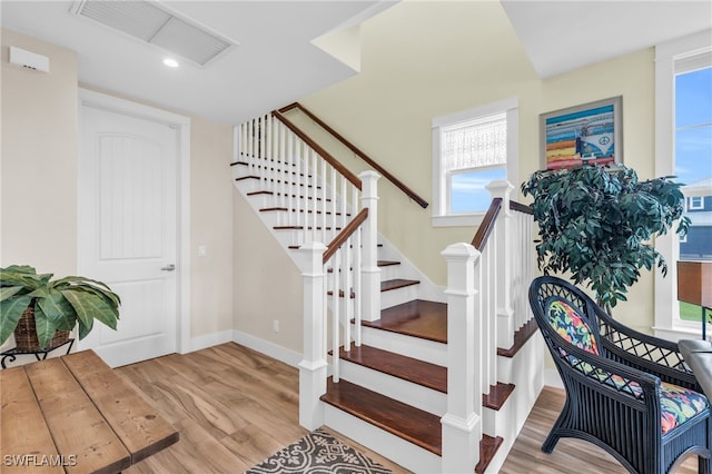 stairs with hardwood / wood-style flooring