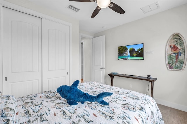 carpeted bedroom featuring ceiling fan and a closet