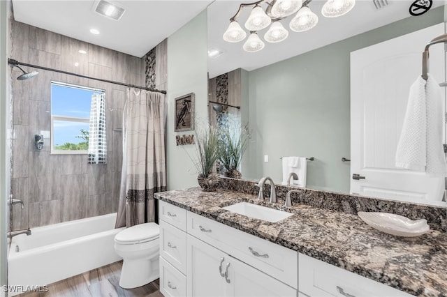 full bathroom featuring wood-type flooring, vanity, toilet, and shower / bathtub combination with curtain