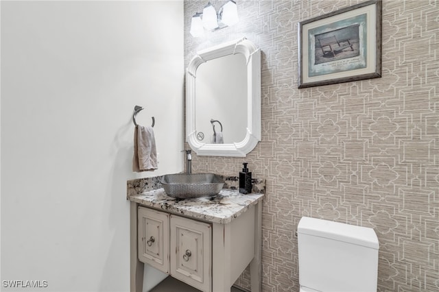 bathroom featuring vanity and toilet