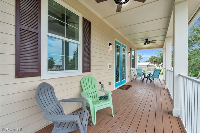 deck with ceiling fan, french doors, and covered porch