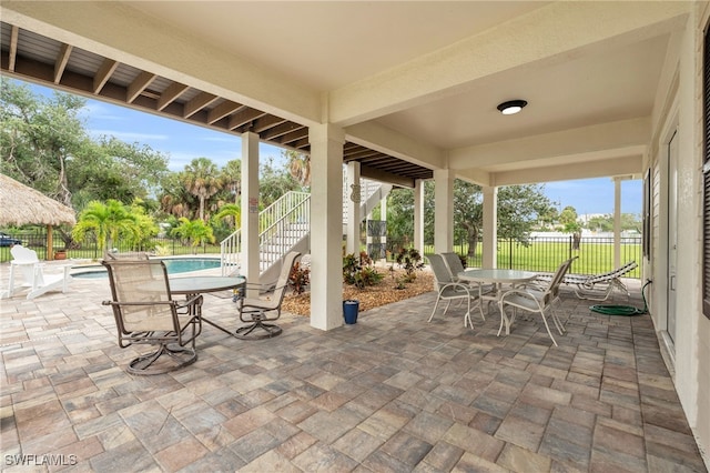 view of patio / terrace with a fenced in pool