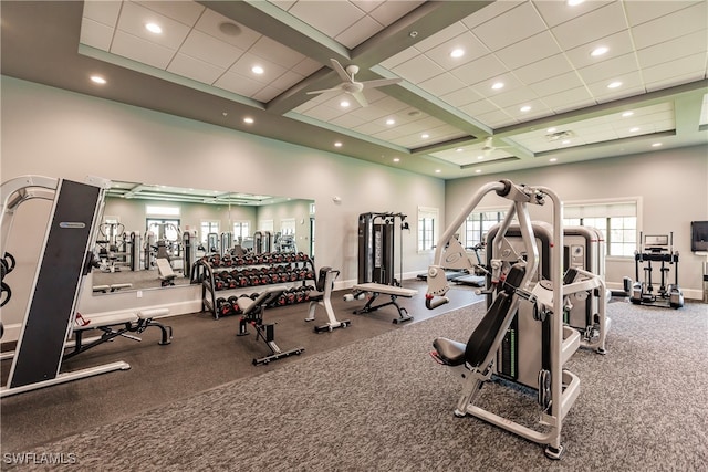 gym featuring carpet floors, a towering ceiling, coffered ceiling, and ceiling fan