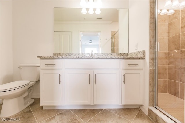 bathroom with toilet, crown molding, vanity, and tile patterned floors