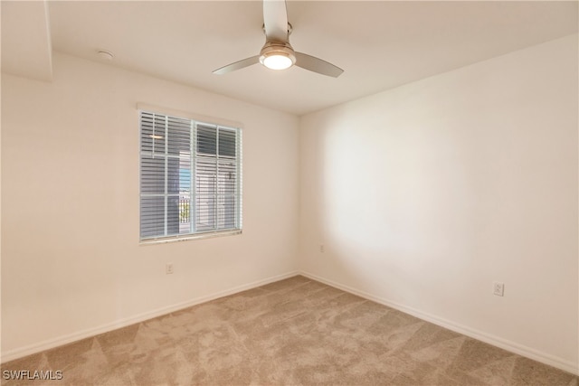 unfurnished room featuring ceiling fan and light colored carpet