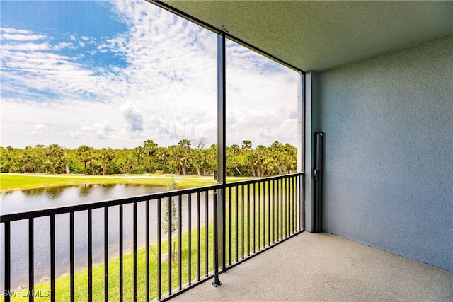 unfurnished sunroom featuring a water view