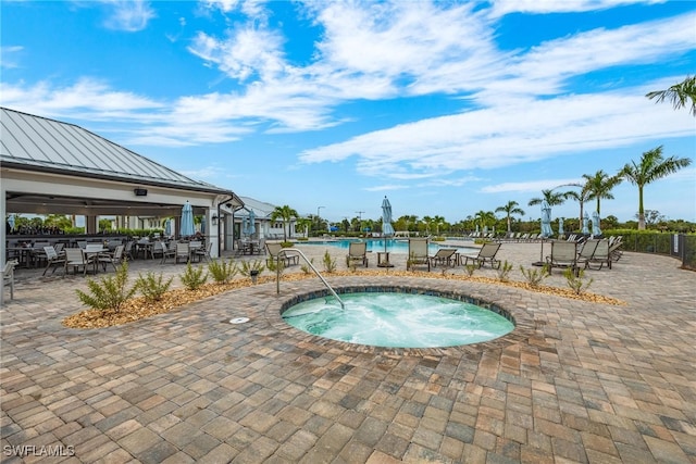 view of swimming pool featuring a patio and a community hot tub