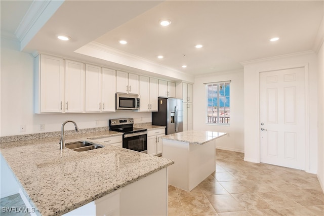 kitchen featuring ornamental molding, appliances with stainless steel finishes, light stone counters, sink, and a center island