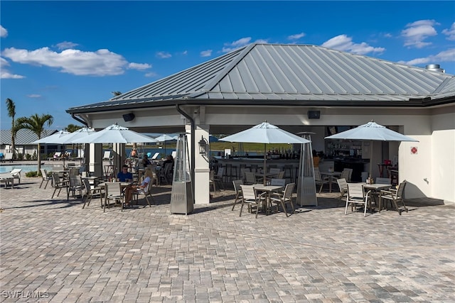 view of patio featuring a community pool and a gazebo