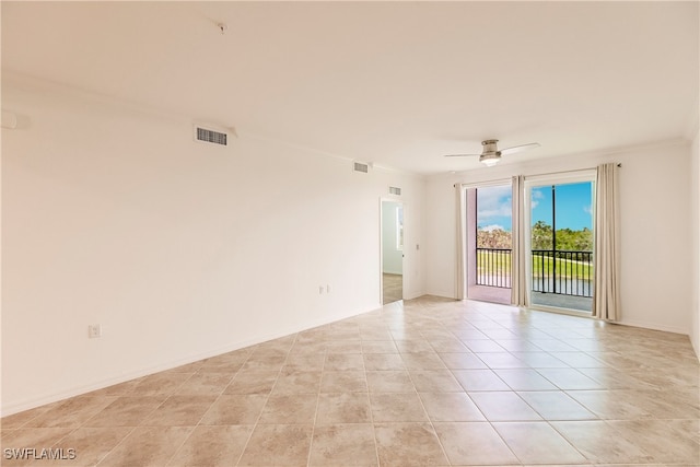 tiled empty room featuring ceiling fan