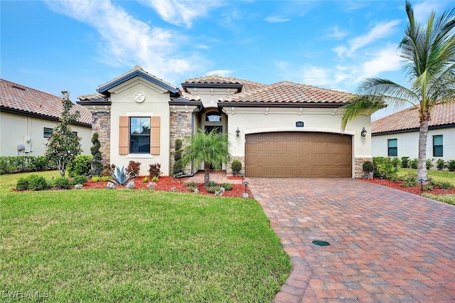 mediterranean / spanish-style home featuring a garage and a front yard