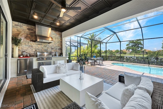 view of patio featuring an outdoor living space, glass enclosure, a grill, and an outdoor kitchen