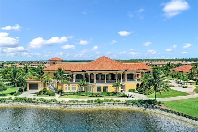 rear view of house with a garage and a water view